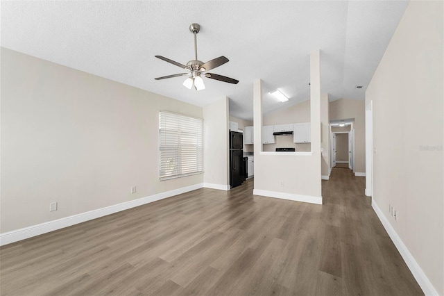 9558 Lupine Ave, Orlando, FL 32824 - unfurnished living room featuring lofted ceiling, ceiling fan, and wood finished floors