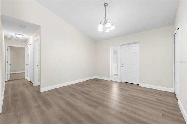 9558 Lupine Ave, Orlando, FL 32824 - unfurnished dining area with a chandelier, light wood-style flooring, and lofted ceiling