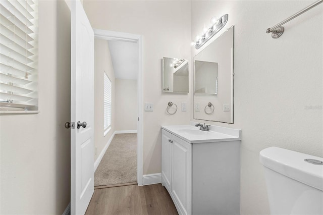 9558 Lupine Ave, Orlando, FL 32824 - half bathroom featuring vanity and wood finished floors