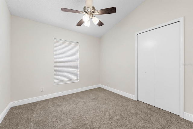 9558 Lupine Ave, Orlando, FL 32824 - unfurnished bedroom with carpet, a closet, lofted ceiling, and ceiling fan