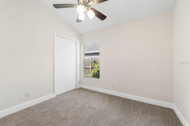 9558 Lupine Ave, Orlando, FL 32824 - spare room with carpet flooring, vaulted ceiling, and a ceiling fan