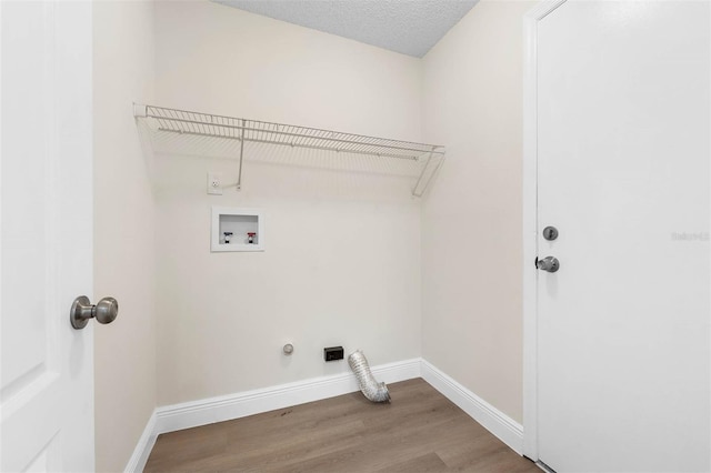 9558 Lupine Ave, Orlando, FL 32824 - laundry room with washer hookup, wood finished floors, gas dryer hookup, and electric dryer hookup