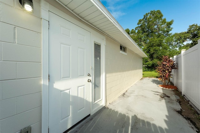 9558 Lupine Ave, Orlando, FL 32824 - property entrance with a patio and concrete block siding