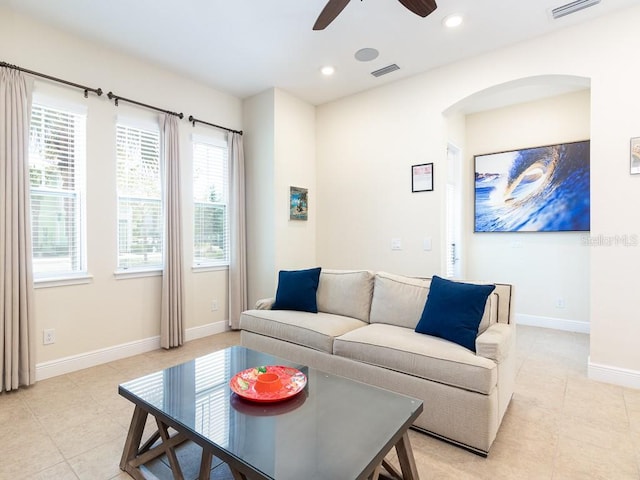 3004 Latitude Ln, Kissimmee, FL 34747 - living area featuring a ceiling fan, light tile patterned floors, arched walkways, and recessed lighting