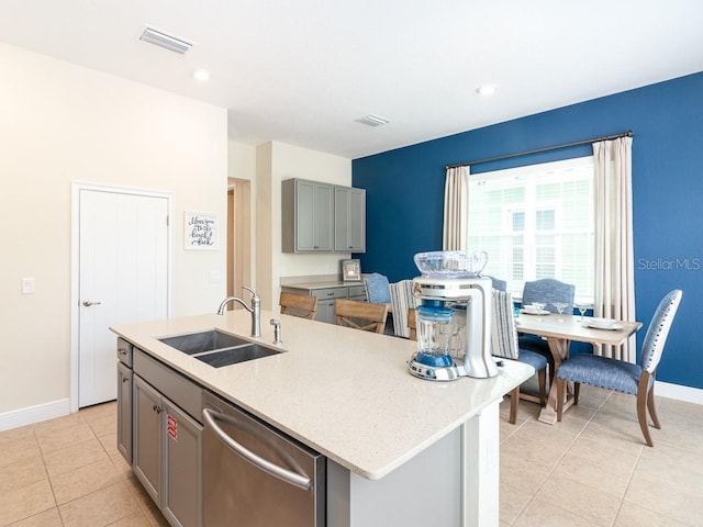 3004 Latitude Ln, Kissimmee, FL 34747 - kitchen with dishwasher, gray cabinets, light tile patterned floors, a kitchen island with sink, and light stone countertops