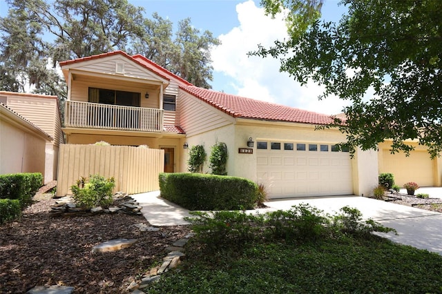 1121 Winged Foot Cir, Winter Springs, FL 32708 - view of front of home with a tile roof, a garage, a balcony, concrete driveway, and stucco siding
