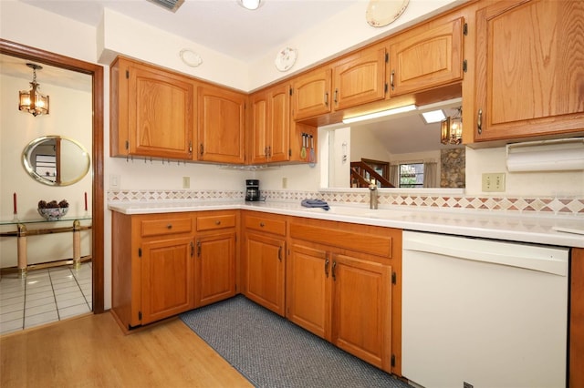 1121 Winged Foot Cir, Winter Springs, FL 32708 - kitchen featuring dishwasher, light countertops, tasteful backsplash, and light wood-type flooring