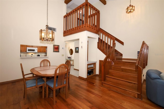 1121 Winged Foot Cir, Winter Springs, FL 32708 - dining room with a chandelier, stairway, wood finished floors, and a high ceiling