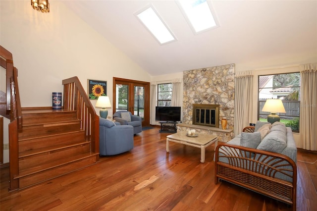 1121 Winged Foot Cir, Winter Springs, FL 32708 - living room with wood finished floors, healthy amount of natural light, stairway, high vaulted ceiling, and a stone fireplace
