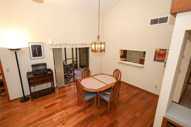 1121 Winged Foot Cir, Winter Springs, FL 32708 - dining space with wood finished floors, a chandelier, and high vaulted ceiling