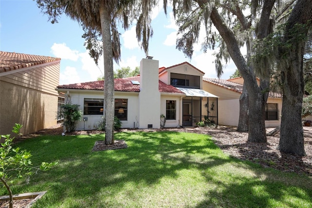 1121 Winged Foot Cir, Winter Springs, FL 32708 - rear view of house with a chimney, a lawn, stucco siding, and a tile roof