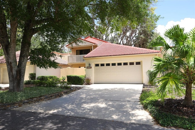 1121 Winged Foot Cir, Winter Springs, FL 32708 - mediterranean / spanish house featuring stucco siding, an attached garage, concrete driveway, and a tiled roof