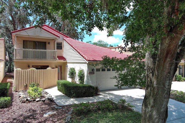 1121 Winged Foot Cir, Winter Springs, FL 32708 - view of front facade featuring a garage, a balcony, a tiled roof, driveway, and stucco siding