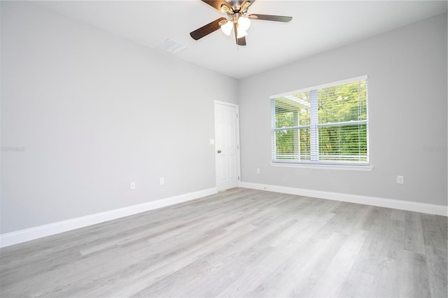 spare room featuring light wood-type flooring and a ceiling fan