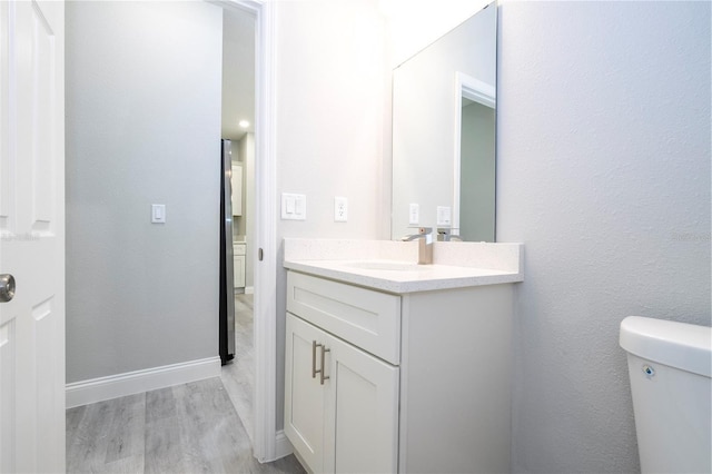 bathroom with vanity and wood finished floors