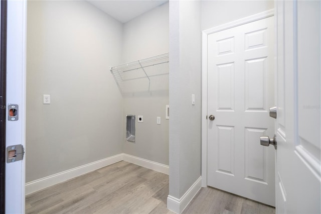 laundry room with hookup for an electric dryer, light wood-style floors, and attic access