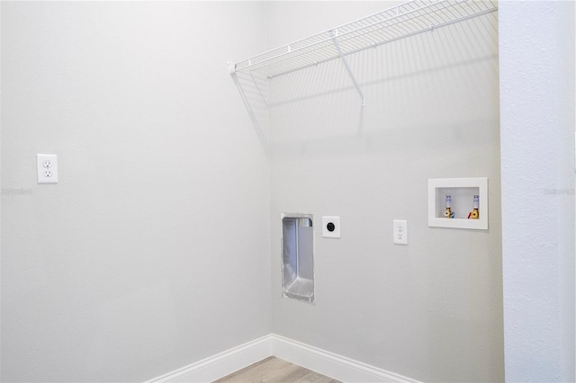 laundry room featuring hookup for an electric dryer, hookup for a washing machine, and light wood-style flooring
