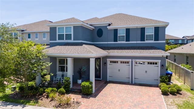 15716 Sweet Lemon Way, Winter Garden, FL 34787 - view of front of house with a porch, stucco siding, a garage, decorative driveway, and a shingled roof