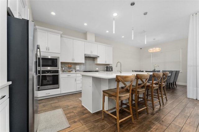 15716 Sweet Lemon Way, Winter Garden, FL 34787 - kitchen featuring appliances with stainless steel finishes, dark wood-type flooring, light countertops, white cabinetry, and recessed lighting