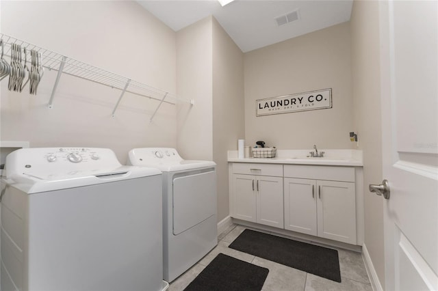 15716 Sweet Lemon Way, Winter Garden, FL 34787 - laundry room featuring washer and clothes dryer, cabinet space, and light tile patterned flooring