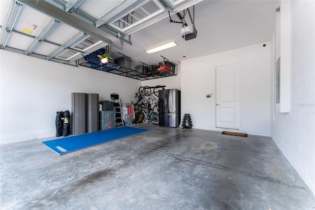 15716 Sweet Lemon Way, Winter Garden, FL 34787 - garage with freestanding refrigerator, a garage door opener, and electric panel