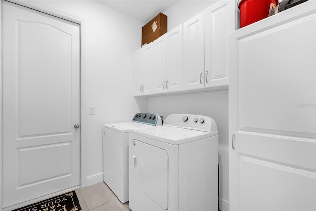 1156 Cavender Creek Rd, Minneola, FL 34715 - laundry room with washing machine and clothes dryer, cabinet space, and light tile patterned floors
