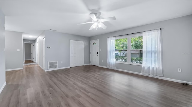 1209 Russell Dr, Ocoee, FL 34761 - unfurnished living room featuring ceiling fan and wood finished floors
