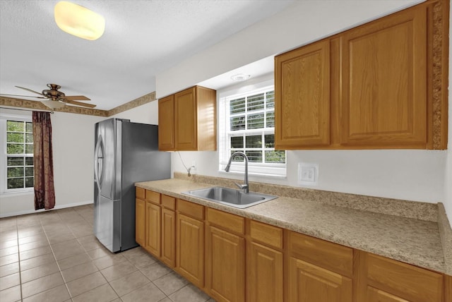 14402 SW 34th Terrace Rd, Ocala, FL 34473 - kitchen featuring freestanding refrigerator, light countertops, plenty of natural light, and a textured ceiling