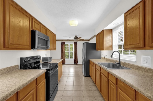 14402 SW 34th Terrace Rd, Ocala, FL 34473 - kitchen featuring stainless steel appliances, a ceiling fan, light countertops, light tile patterned flooring, and brown cabinetry