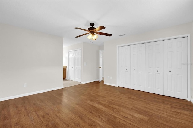 14402 SW 34th Terrace Rd, Ocala, FL 34473 - unfurnished bedroom featuring wood finished floors, two closets, and a ceiling fan