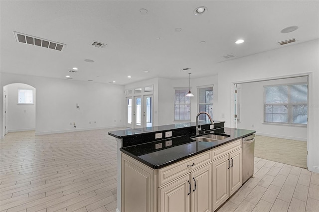 11837 Cave Run Ave, Windermere, FL 34786 - kitchen featuring stainless steel dishwasher, open floor plan, an island with sink, cream cabinets, and french doors