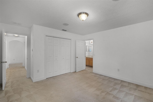 11837 Cave Run Ave, Windermere, FL 34786 - unfurnished bedroom featuring light carpet, a textured ceiling, and a closet