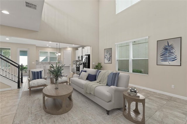 15019 Valverse Aly, Winter Garden, FL 34787 - living area with stairway, a towering ceiling, recessed lighting, and light tile patterned flooring