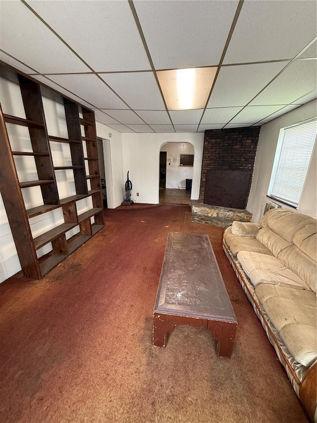 1425 26th St, Orlando, FL 32805 - living room with arched walkways, carpet flooring, a paneled ceiling, and a fireplace