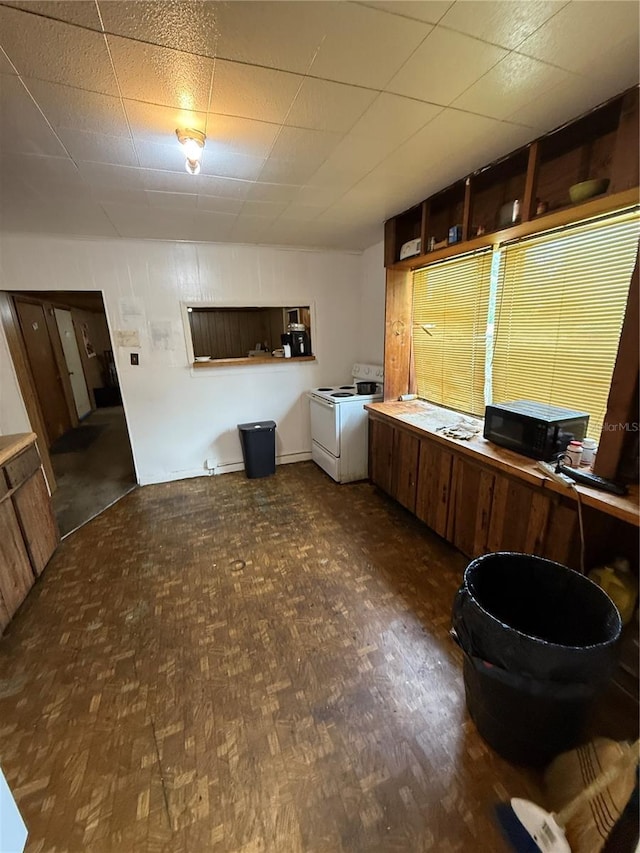 1425 26th St, Orlando, FL 32805 - kitchen with washing machine and dryer, black microwave, and parquet floors