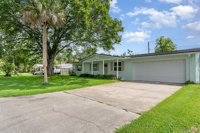 323 Scotland Dr, Daytona Beach, FL 32117 - ranch-style home featuring a front lawn, an attached garage, and concrete driveway