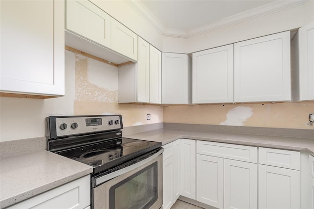 323 Scotland Dr, Daytona Beach, FL 32117 - kitchen with stainless steel electric range, crown molding, white cabinets, and light stone countertops