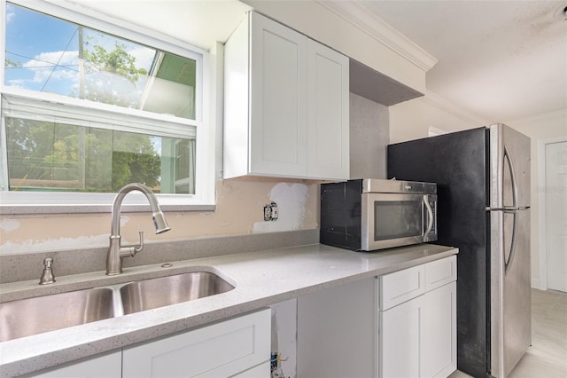 323 Scotland Dr, Daytona Beach, FL 32117 - kitchen featuring stainless steel appliances, white cabinetry, and light stone counters