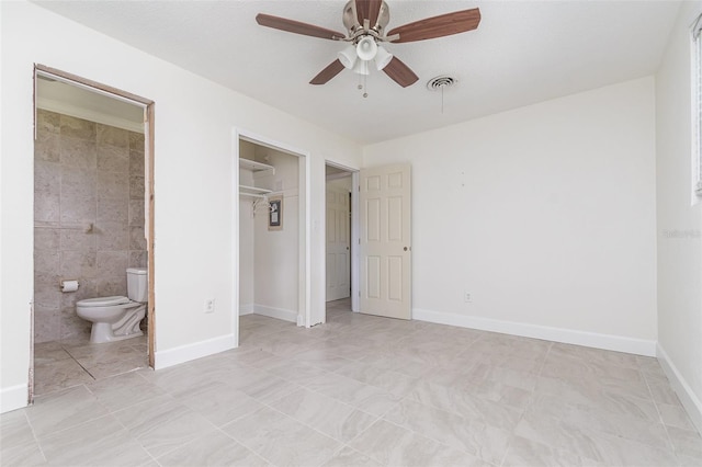 323 Scotland Dr, Daytona Beach, FL 32117 - unfurnished bedroom featuring a closet, connected bathroom, and a ceiling fan