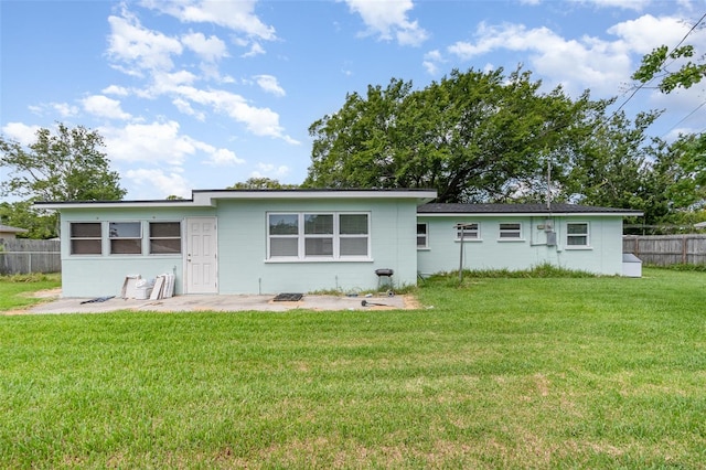 323 Scotland Dr, Daytona Beach, FL 32117 - rear view of property with concrete block siding and a patio area