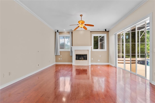 875 Bentley Green Cir, Winter Springs, FL 32708 - unfurnished living room with ornamental molding, a ceiling fan, wood finished floors, and a high end fireplace