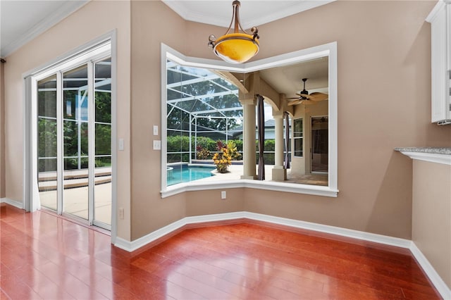 875 Bentley Green Cir, Winter Springs, FL 32708 - unfurnished dining area featuring a ceiling fan, wood-type flooring, a sunroom, and crown molding
