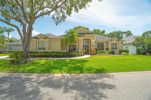 875 Bentley Green Cir, Winter Springs, FL 32708 - ranch-style house featuring french doors, stucco siding, and a front yard