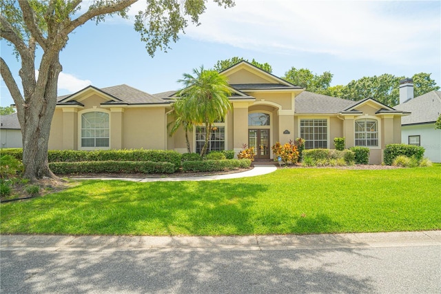 875 Bentley Green Cir, Winter Springs, FL 32708 - single story home with french doors, a front yard, and stucco siding