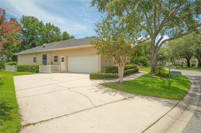 875 Bentley Green Cir, Winter Springs, FL 32708 - view of front of house with a garage, stucco siding, a front yard, and concrete driveway