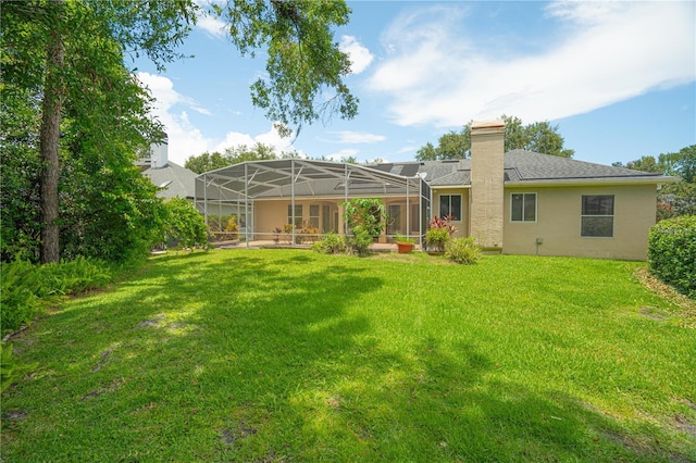 875 Bentley Green Cir, Winter Springs, FL 32708 - back of property featuring a lawn, stucco siding, a chimney, and glass enclosure