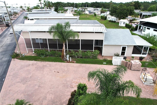 1115 Deer Creek Blvd, Davenport, FL 33837 - rear view of house featuring a sunroom and a residential view