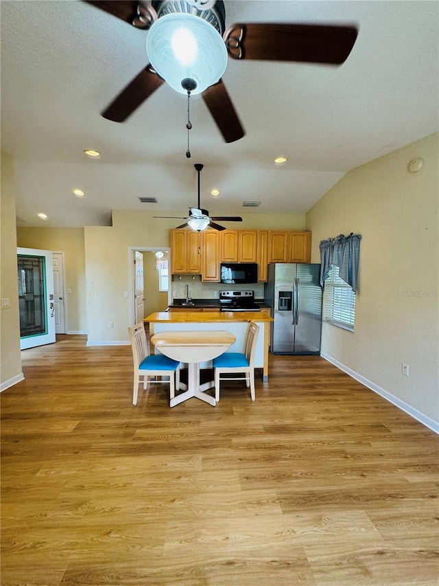 1115 Deer Creek Blvd, Davenport, FL 33837 - kitchen featuring appliances with stainless steel finishes, ceiling fan, light wood finished floors, and recessed lighting