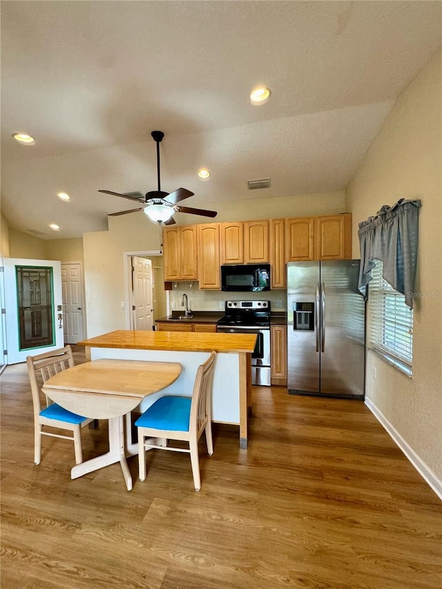 1115 Deer Creek Blvd, Davenport, FL 33837 - kitchen featuring stainless steel appliances, dark wood-style flooring, dark countertops, ceiling fan, and recessed lighting
