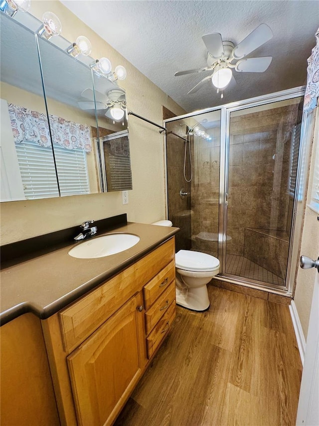 1115 Deer Creek Blvd, Davenport, FL 33837 - full bathroom with wood finished floors, ceiling fan, vanity, a stall shower, and a textured ceiling